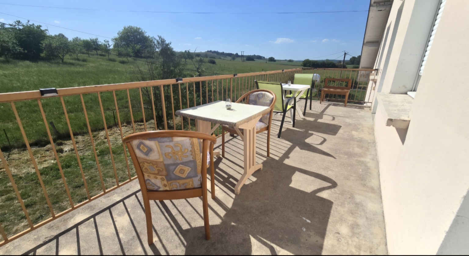 Balcon commun aménagé avec vue verdoyante à la Résidence Les Poiriers